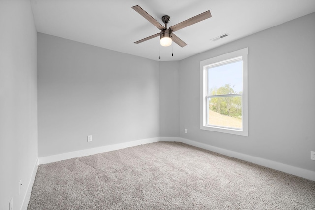 carpeted spare room featuring ceiling fan