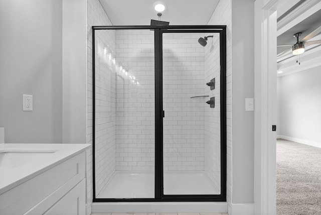 bathroom featuring walk in shower, ceiling fan, and vanity