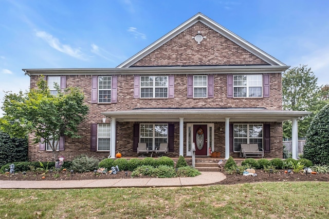 view of front of property featuring a front yard and covered porch