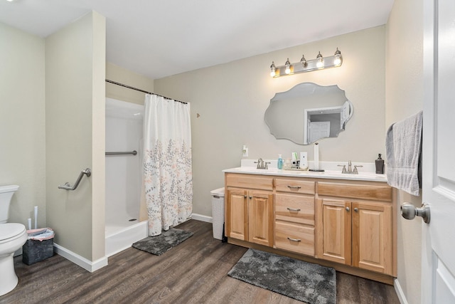 bathroom featuring a shower with curtain, vanity, toilet, and hardwood / wood-style floors