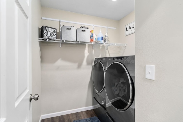 laundry room with hardwood / wood-style flooring and washing machine and clothes dryer