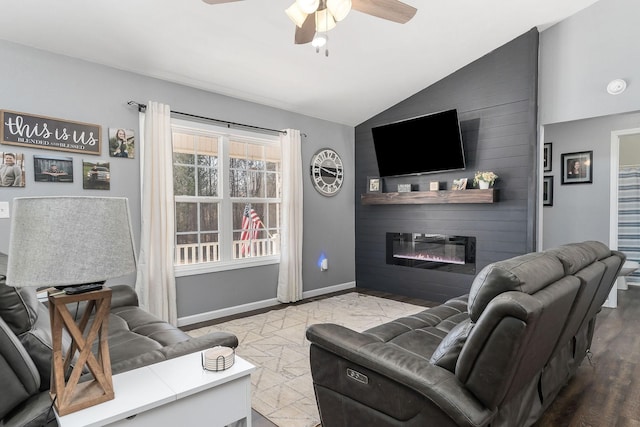 living room with vaulted ceiling, a large fireplace, and ceiling fan