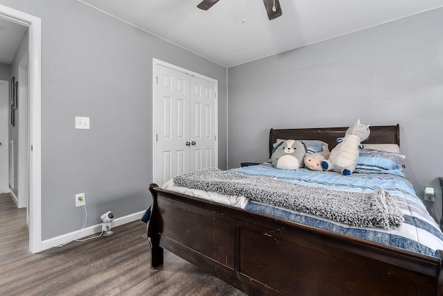 bedroom with ceiling fan, dark hardwood / wood-style flooring, and a closet