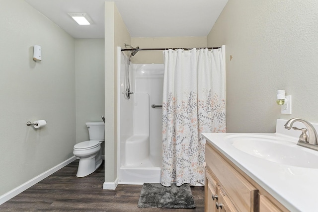 bathroom featuring a shower with shower curtain, vanity, toilet, and hardwood / wood-style floors