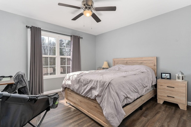 bedroom with dark wood-type flooring and ceiling fan