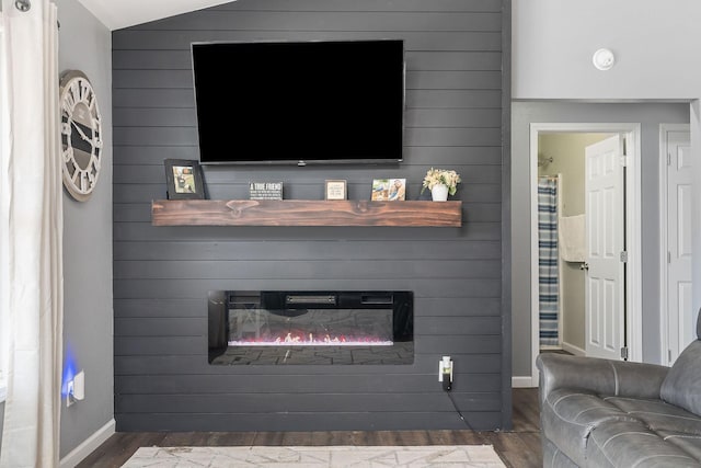 living room with dark hardwood / wood-style flooring and a fireplace