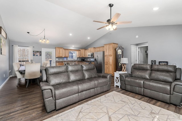 living room with dark hardwood / wood-style floors, ceiling fan with notable chandelier, and high vaulted ceiling