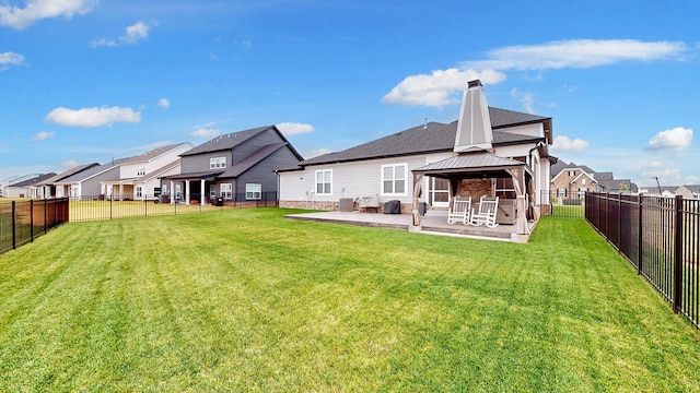 rear view of house featuring a gazebo, central AC, a patio, and a lawn