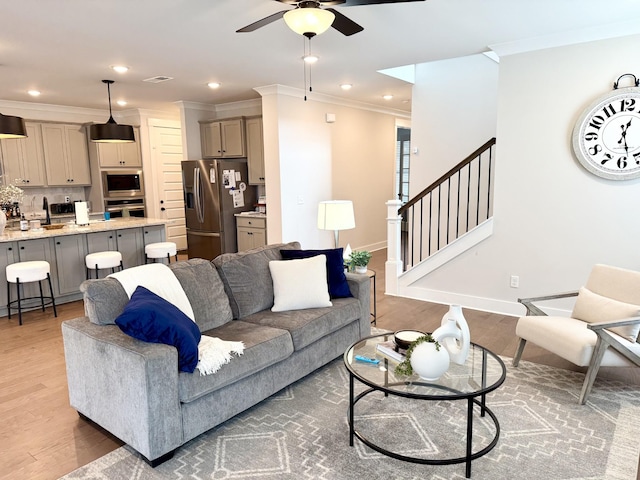 living room featuring sink, crown molding, dark wood-type flooring, and ceiling fan