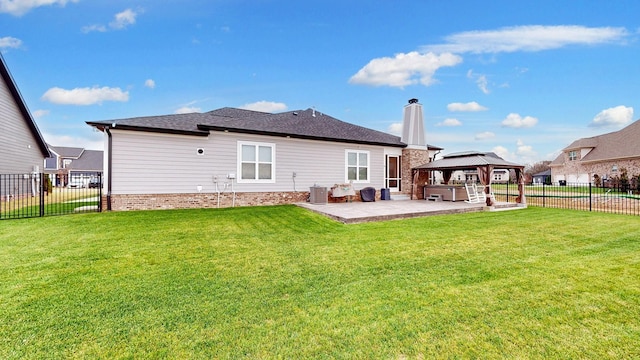 rear view of property with a gazebo, a yard, central AC, and a patio area