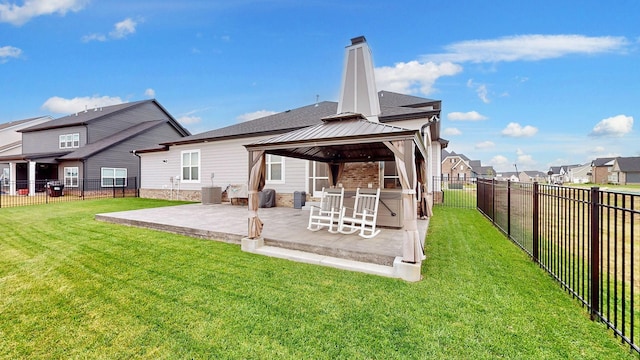 rear view of property with central AC unit, a gazebo, a lawn, and a patio