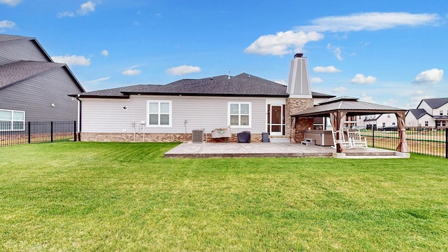 rear view of house with a gazebo, a yard, a patio area, and central air condition unit