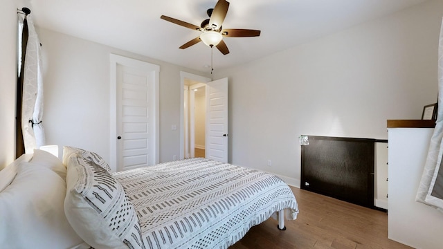 bedroom with ceiling fan and light hardwood / wood-style floors