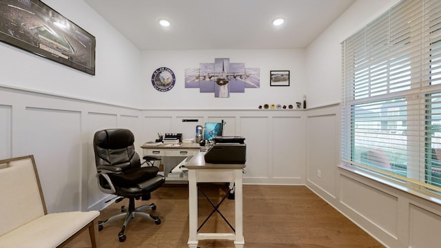 office space with plenty of natural light and hardwood / wood-style floors