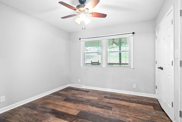 spare room featuring ceiling fan and dark hardwood / wood-style flooring