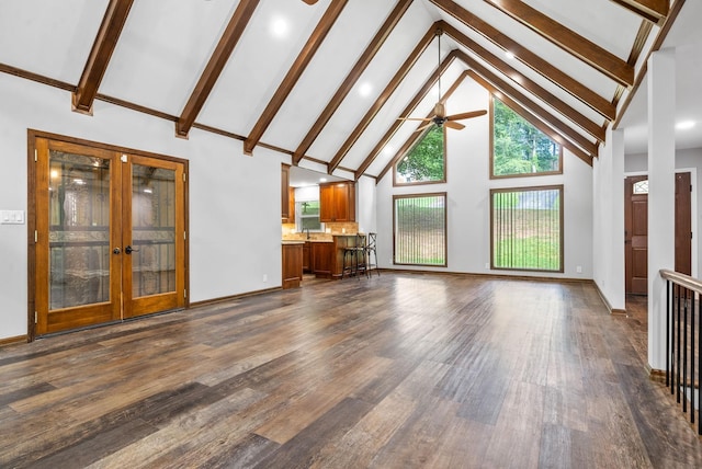 unfurnished living room featuring plenty of natural light, dark hardwood / wood-style floors, and french doors