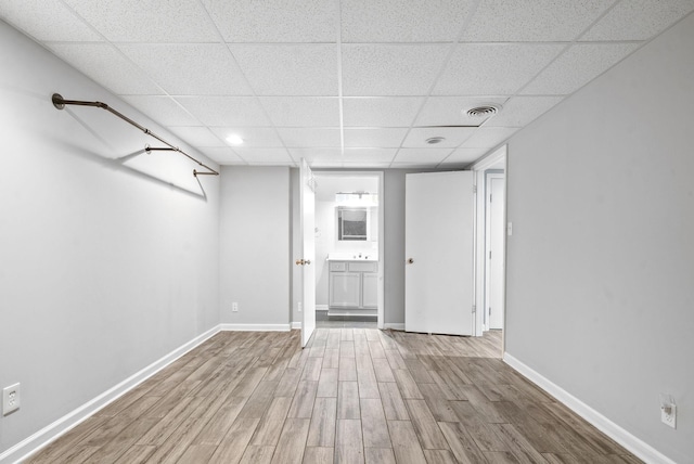 interior space with wood-type flooring and a paneled ceiling