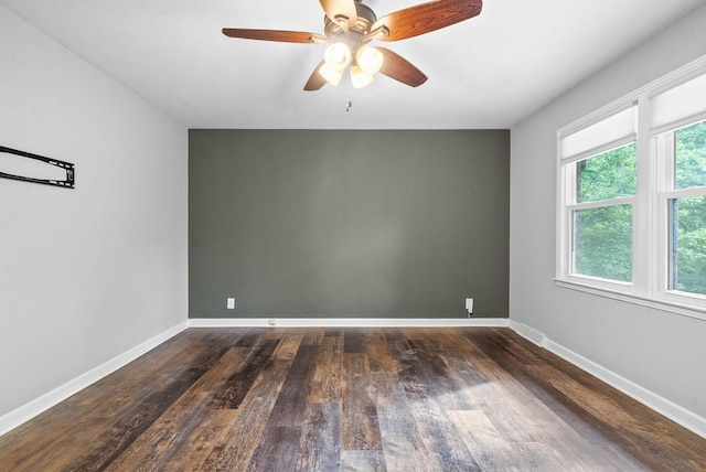 unfurnished room featuring dark hardwood / wood-style flooring and ceiling fan