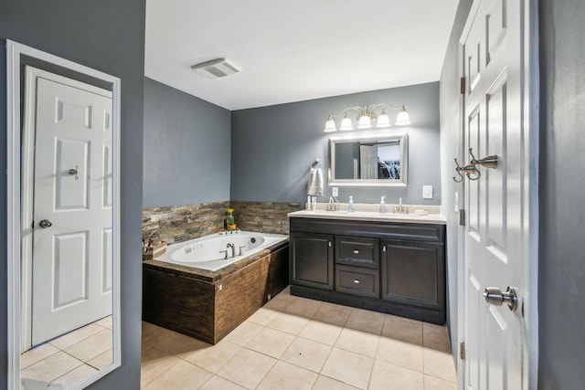 bathroom with tile patterned flooring, a bath, and vanity