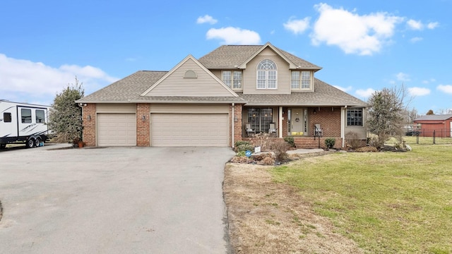 view of front of house featuring a garage, a porch, and a front yard