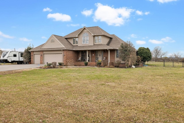 view of front of home featuring a garage, a front lawn, and covered porch