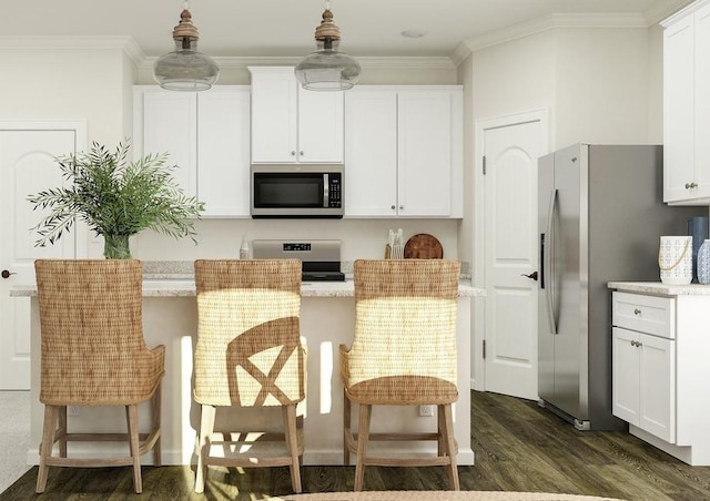 kitchen featuring dark wood-type flooring, a breakfast bar, white cabinetry, ornamental molding, and appliances with stainless steel finishes