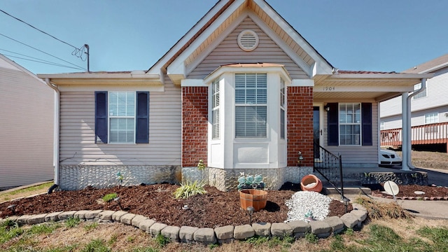 view of front of property with entry steps and brick siding