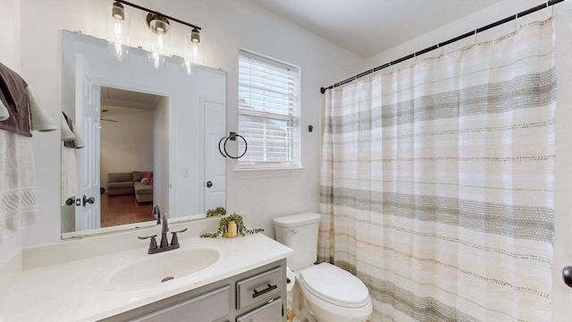 full bathroom with curtained shower, vanity, and toilet