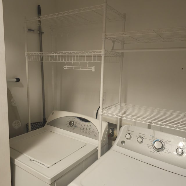 clothes washing area featuring washer and dryer and laundry area