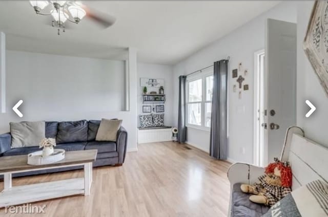 living room with ceiling fan and light hardwood / wood-style floors