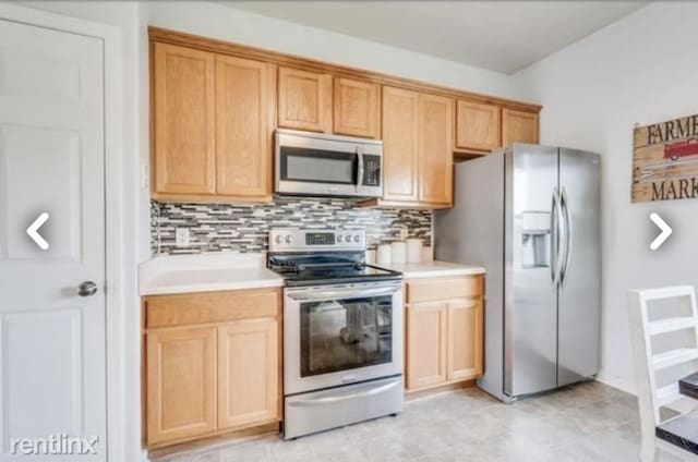 kitchen featuring tasteful backsplash, light brown cabinets, and appliances with stainless steel finishes