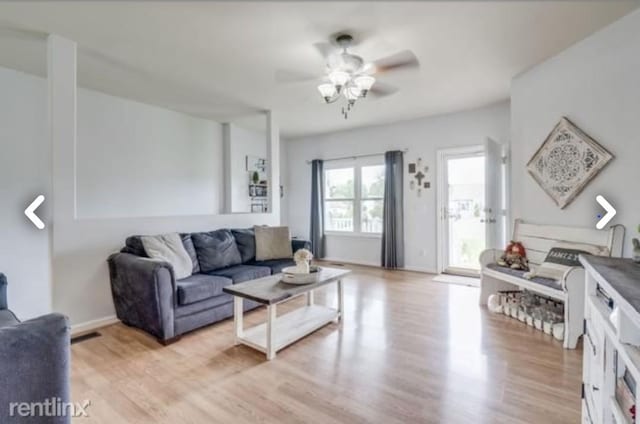 living room featuring ceiling fan and light hardwood / wood-style flooring