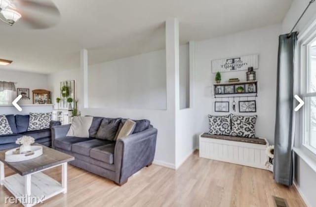 living room featuring radiator, light hardwood / wood-style flooring, and ceiling fan