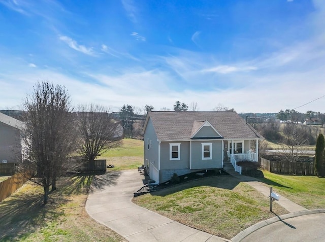 bungalow featuring a front lawn, fence, and covered porch