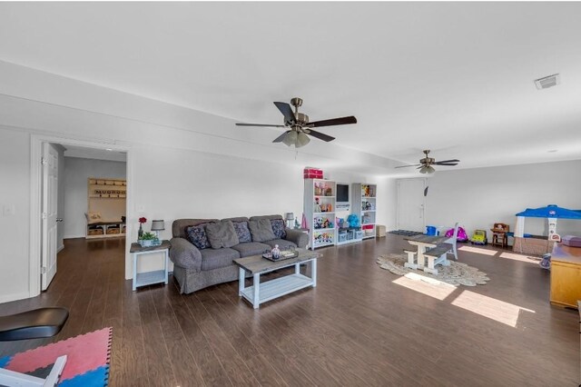 living area featuring wood finished floors, visible vents, and ceiling fan