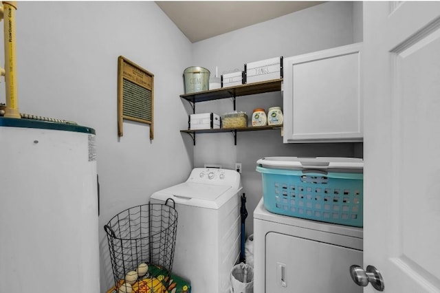 laundry area with cabinet space and separate washer and dryer