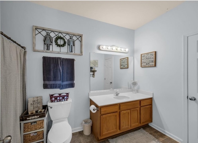 full bathroom with vanity, tile patterned floors, toilet, and baseboards