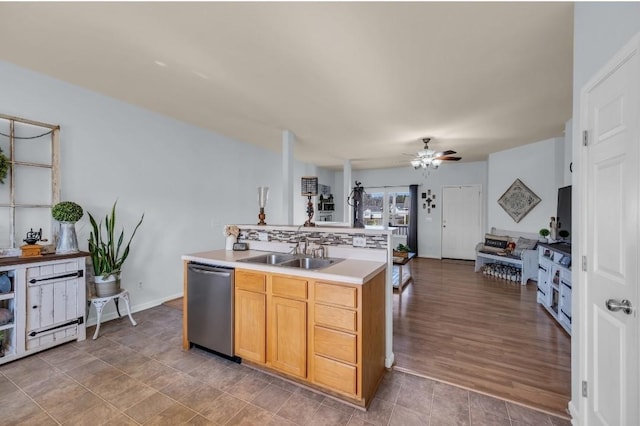 kitchen with tasteful backsplash, ceiling fan, dishwasher, light countertops, and a sink