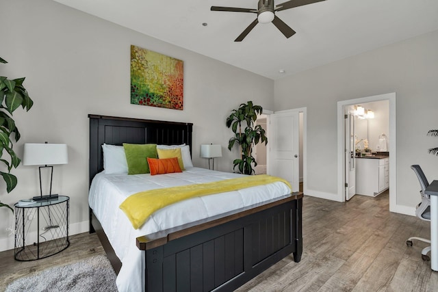 bedroom featuring connected bathroom, hardwood / wood-style floors, and ceiling fan