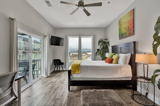 bedroom featuring ceiling fan, access to exterior, and hardwood / wood-style floors