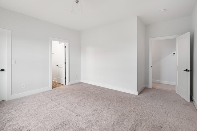 unfurnished room featuring light colored carpet