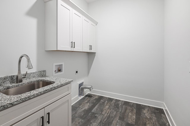 clothes washing area featuring sink, dark hardwood / wood-style flooring, cabinets, washer hookup, and hookup for an electric dryer