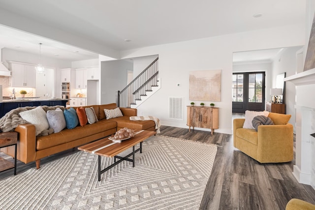 living room with sink and wood-type flooring