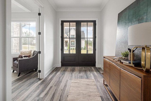 entryway with french doors, ornamental molding, and light hardwood / wood-style floors