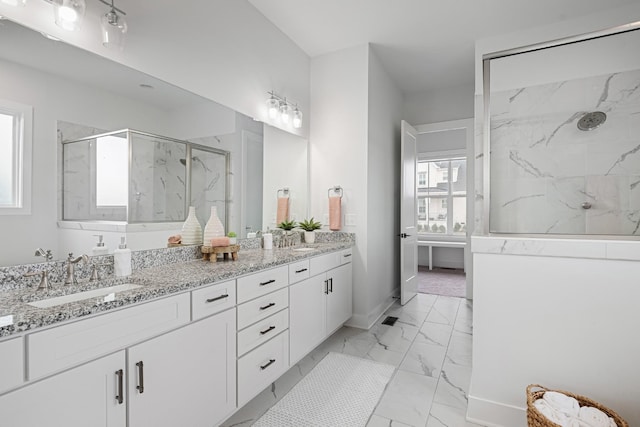 bathroom featuring vanity and tiled shower