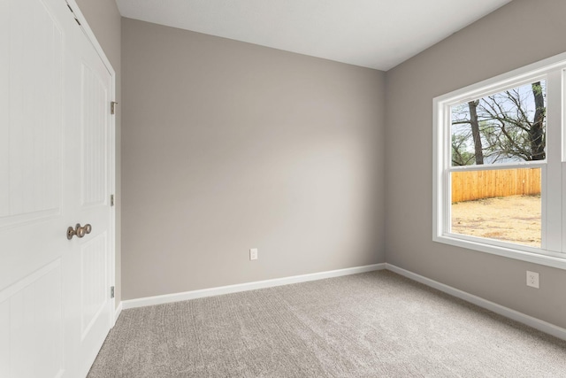 carpeted spare room with baseboards