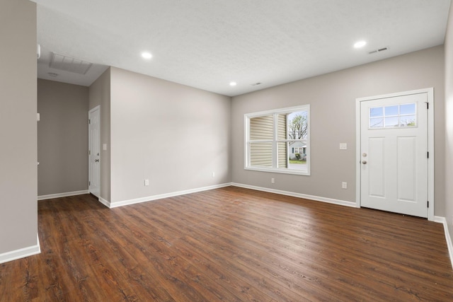 foyer featuring baseboards, visible vents, recessed lighting, and dark wood-type flooring