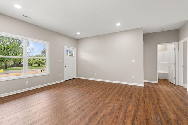 unfurnished living room featuring baseboards, visible vents, wood finished floors, and recessed lighting