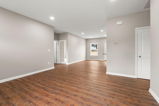 unfurnished room featuring baseboards, visible vents, recessed lighting, and dark wood-type flooring