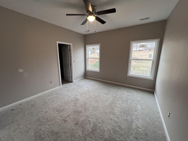 carpeted empty room featuring ceiling fan